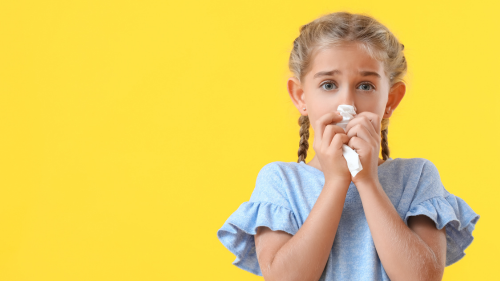 Child sneezing Yellow Background.png